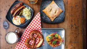 Sausage plate, pretzel with obatzda, and apple strudel at Drake's Dealership